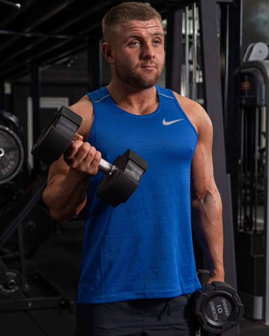 Client training with dumbbells at Complete Performance