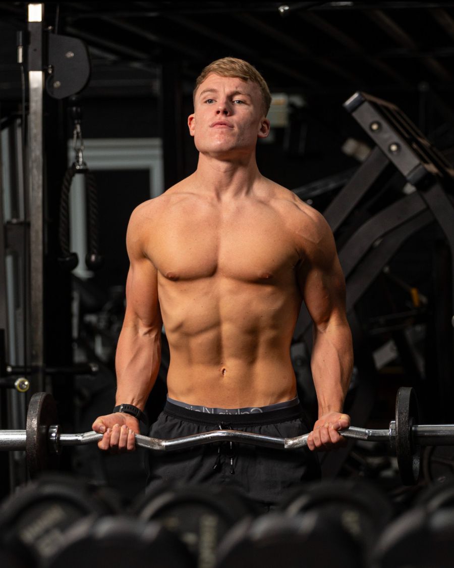 Client training with barbell at Complete Performance